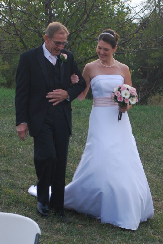 Katie is escorted by her father Richard